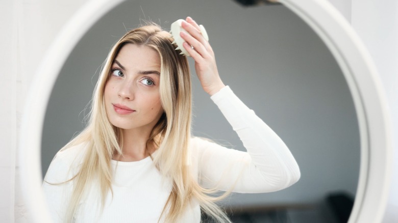 woman using scalp massager