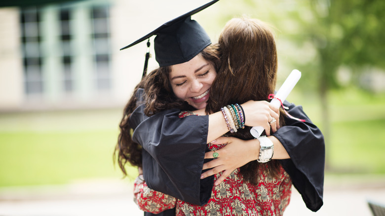Graduate hugging partner