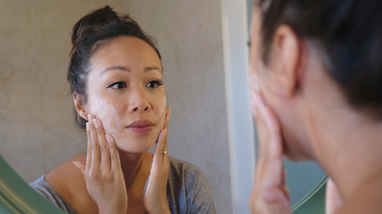 Woman exfoliating her face