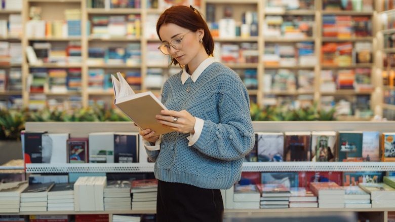 Woman reading in bookstore