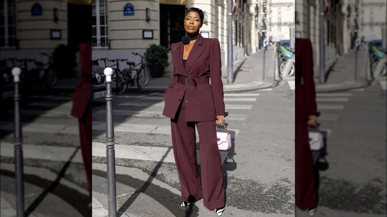 Woman posting on street wearing a suit