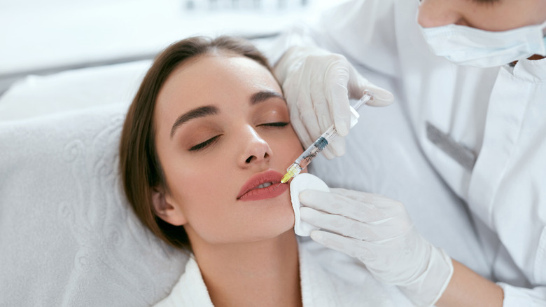 Woman receiving lip flip treatment