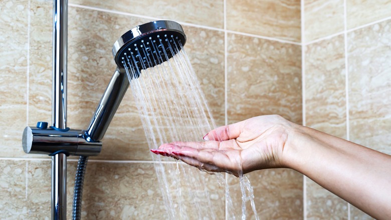 Hand feeling shower water 