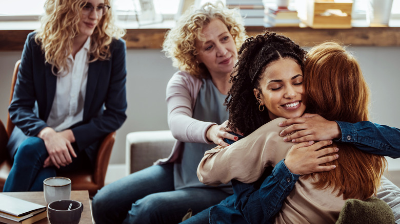 Women hug in therapy session