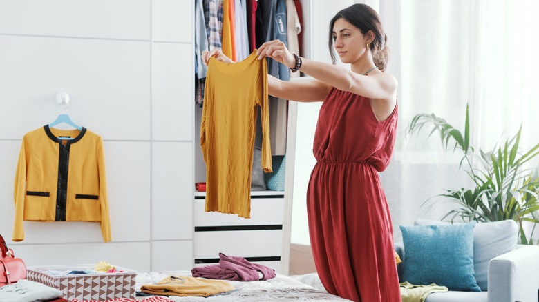 Woman putting clothes away