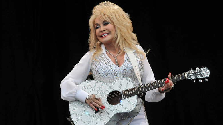 Dolly Parton playing guitar