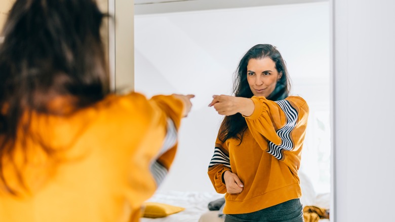 Woman pointing to self mirror