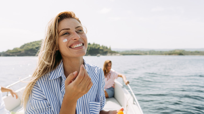 woman on boat with sunscreen