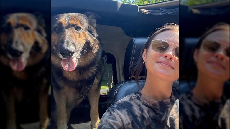 Kathryn Kelly posing with her dog without makeup