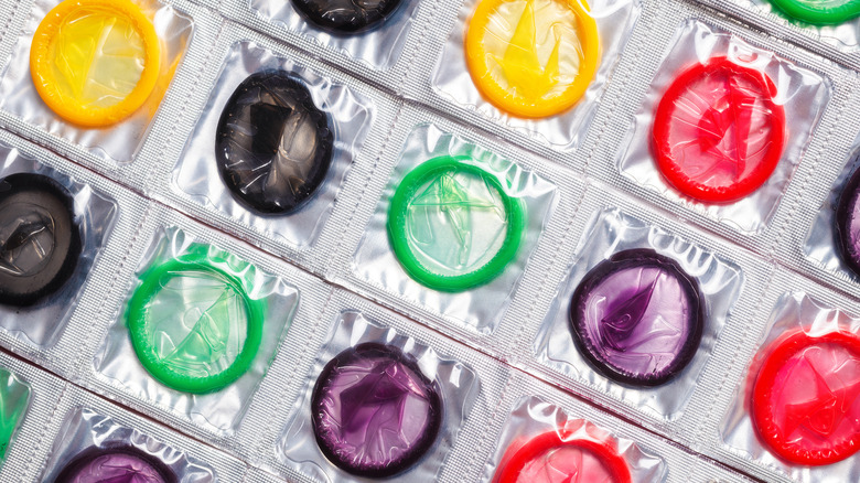 A close-up of multi-colored wrapped condoms 