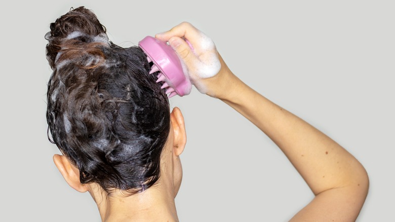 A woman massaging her scalp