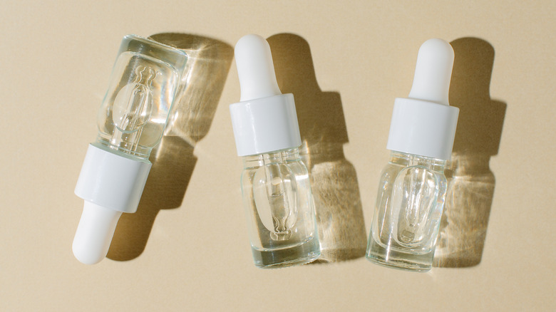 A bottle of serums on a table