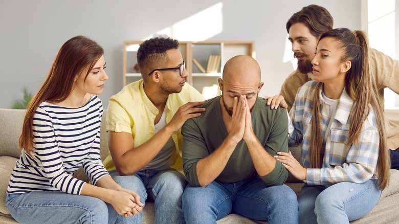 Group consoling an upset friend