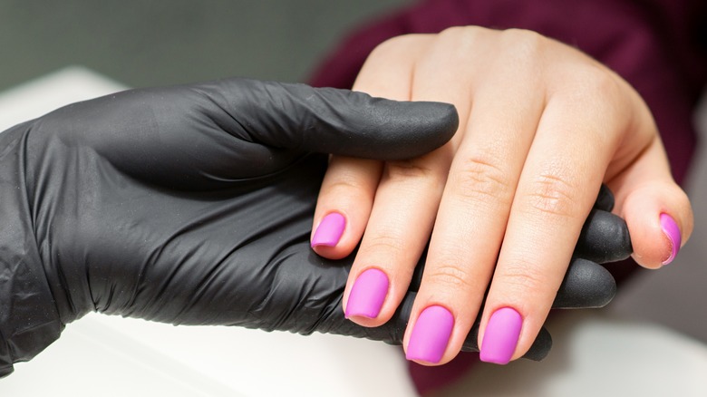 Pink nails black glove
