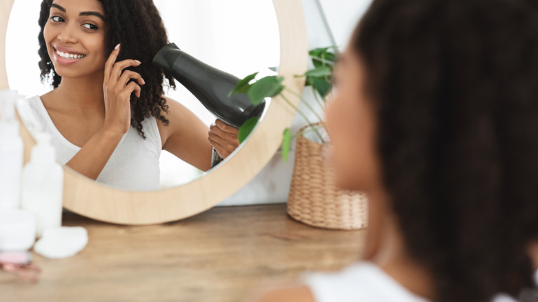 Woman blow-drying her hair