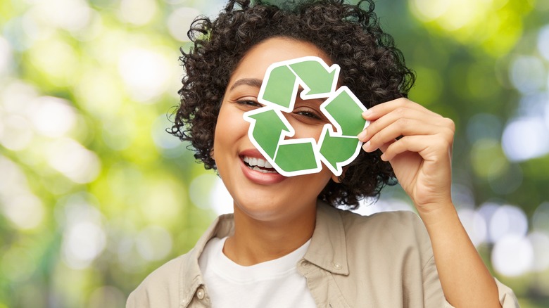 Woman holding a recycle symbol