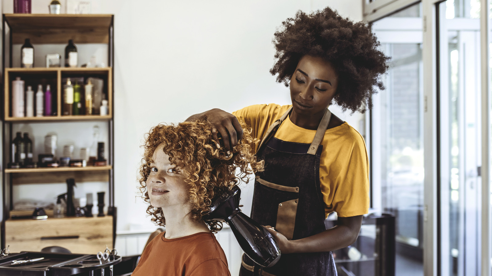 Crazy girl with scissors. Hairdresser in action. Stock Photo