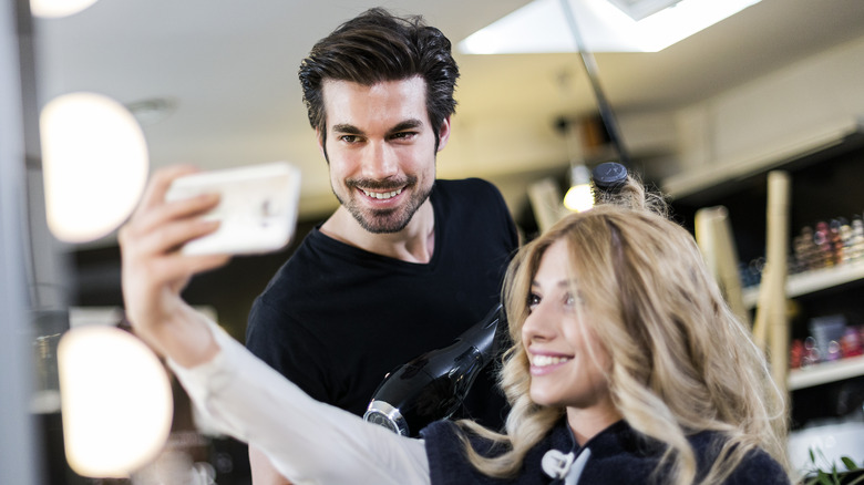 Woman taking a photo in a hair salon