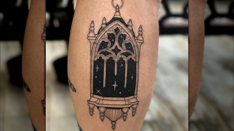 Blackwork tattoo of cathedral window